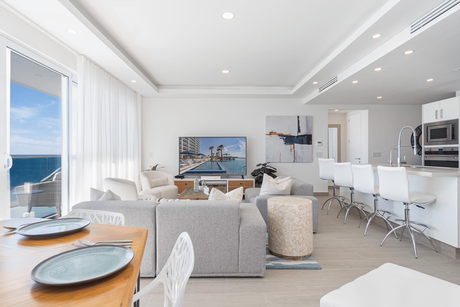 Living room with a comfy couch, coffee table, and a television mounted on the wall